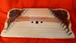 A trapezoidal, carved gusli.